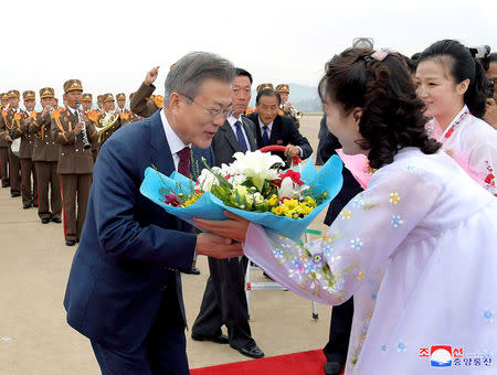 South Korean President Moon Jae-in receives flowers at an airport before travelling to Mount Paektu, in this photo released by North Korea's Korean Central News Agency (KCNA) on September 21, 2018. KCNA via REUTERS