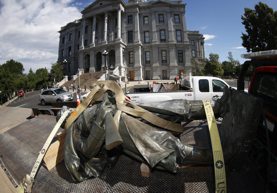 The Civil War Monument statue is strapped to the bed of a flatbed tow truck after it was toppled from its pedestal in front of the State Capitol Thursday, June 25, 2020, in Denver. The monument, which portrays a Union Army soldier and was erected in 1909, was targeted during demonstrations over the death of George Floyd before the statue was pulled down overnight by four individuals. (AP Photo/David Zalubowski)