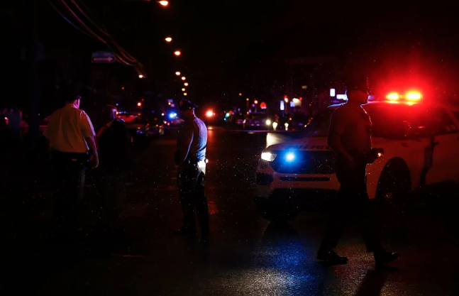 Philadelphia police gather after multiple people were shot in Southwest Philadelphia in July. 
