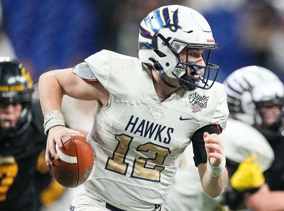 Decatur Central Hawks quarterback Bo Polston (12) rushes up the field Friday, Nov. 24, 2023, during the IHSAA Class 3A football state championship game at Lucas Oil Stadium in Indianapolis. The Fort Wayne Snider Panthers defeated the Decatur Central Hawks, 33-8.