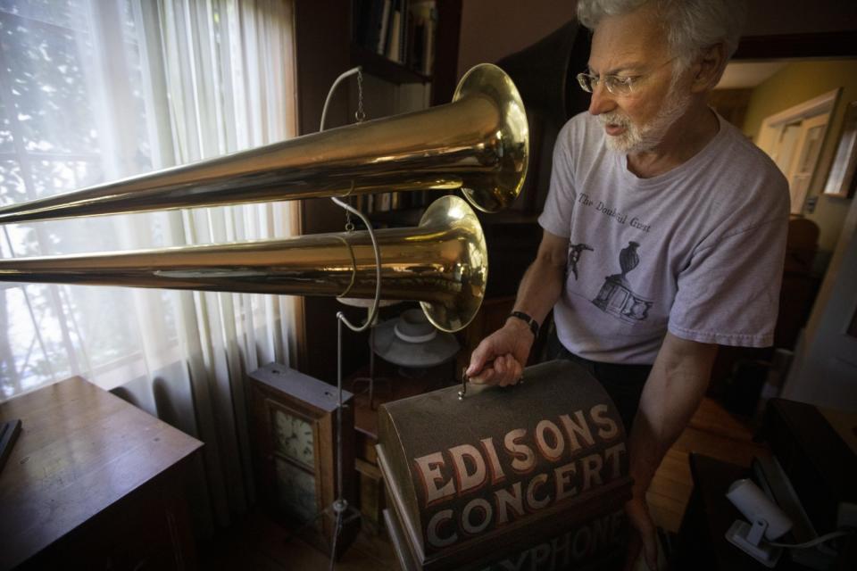 Collector John Levin stands next to what he describes as "a 1900 double-horned phonograph"