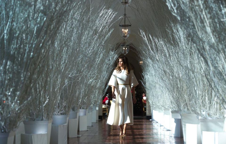 Melania Trump walks through Christmas decorations in the White House in 2017.