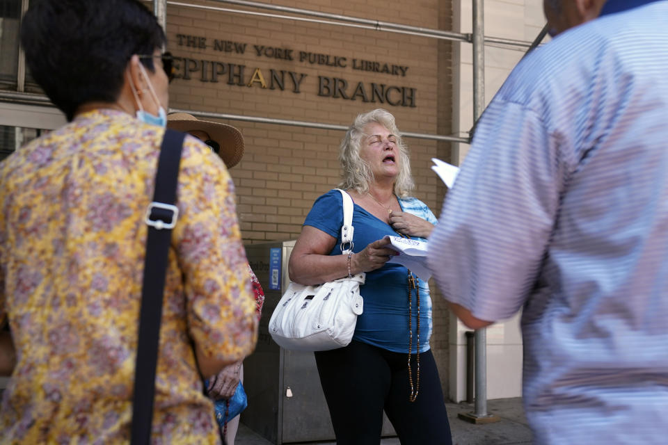 A group of Catholics pray outside a public library during a Drag Story Hour in New York, Friday, June 17, 2022. The "rosary rally" was in protest of the drag story time. (AP Photo/Seth Wenig)