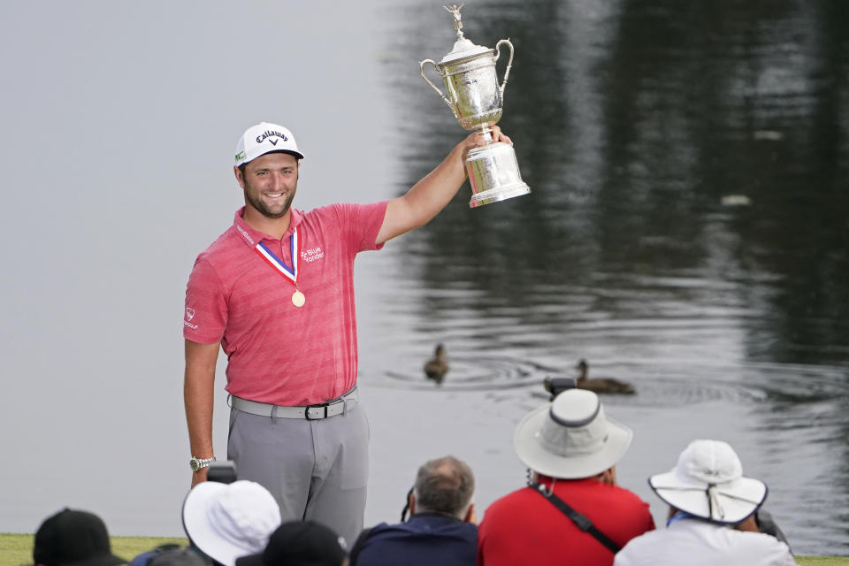 Jon Rahm, of Spain, holds the champions trophy for photographers after the final round of the U.S. Open Golf Championship, Sunday, June 20, 2021, at Torrey Pines Golf Course in San Diego. (AP Photo/Jae C. Hong)