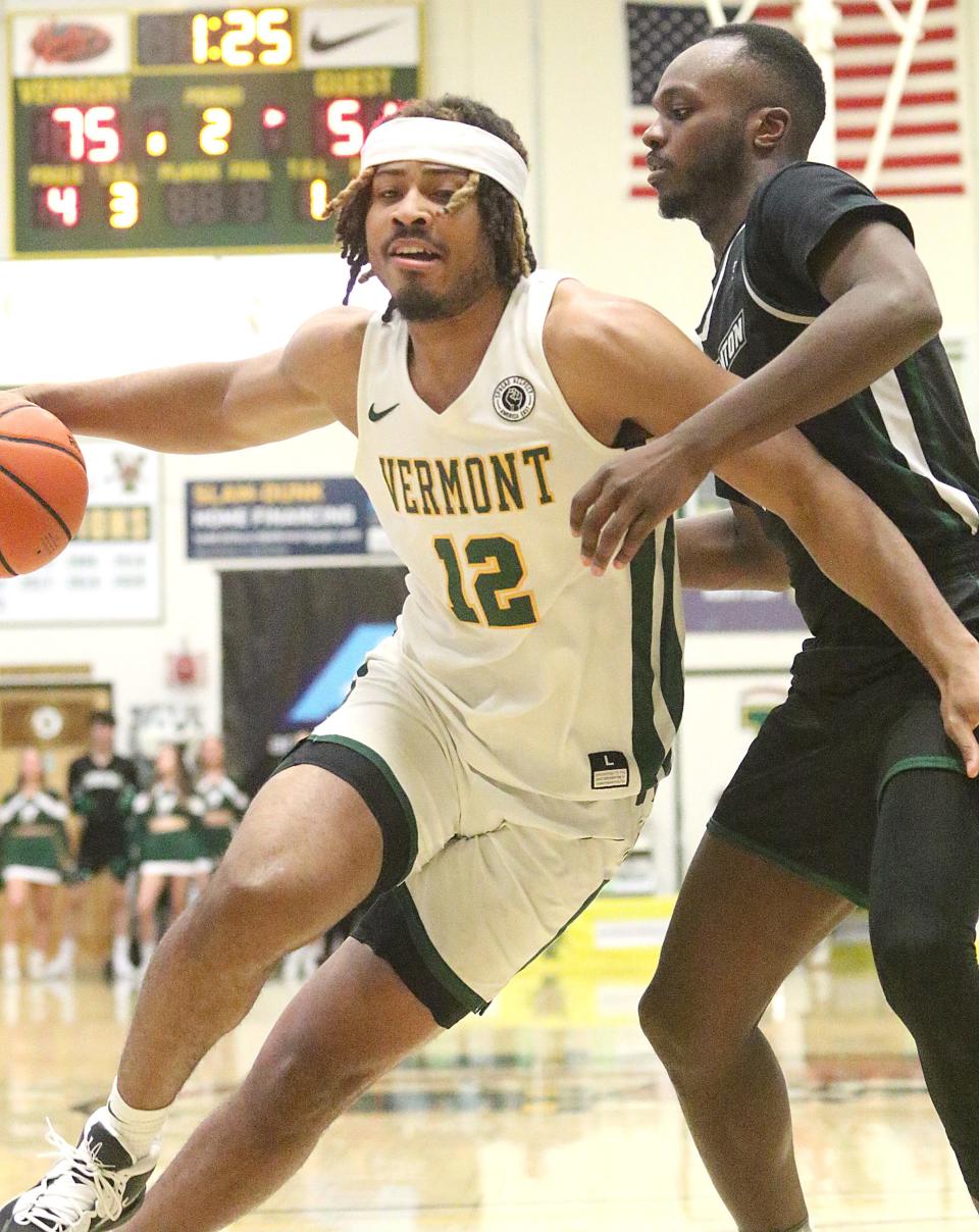 Vermont's Perry Smith Jr fights his way to the hoop during the Catamounts 79-57 win over Binghamton in the 2023 America East semifinals at Patrick Gym.