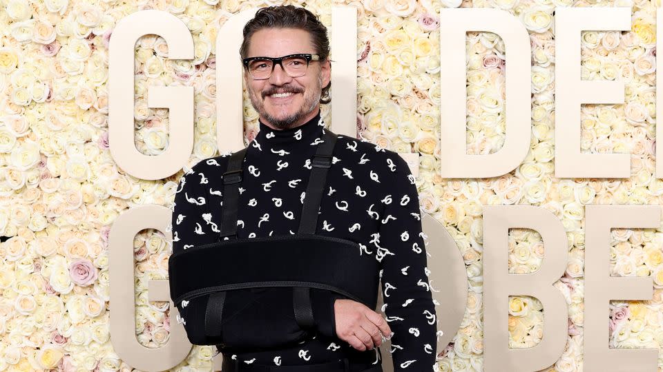 Pedro Pascal arrived with his arm in a sling matching his all-black Bottega Veneta outfit, which featured a knot-detailed sweater and black wool pants. - Monica Schipper/GA/The Hollywood Reporter/Getty Images