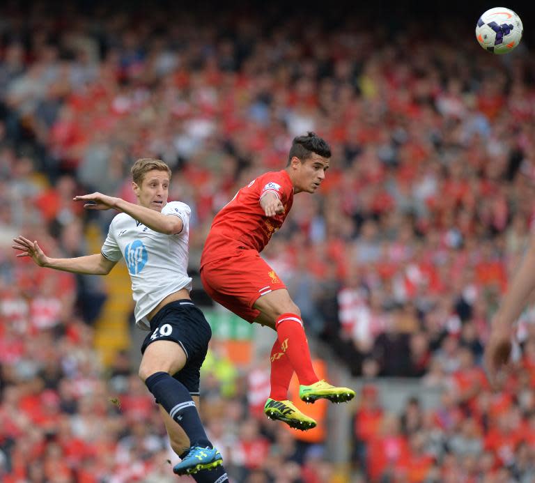 Liverpool&#39;s Philippe Coutinho (R) heads the ball away from Tottenham Hotspur&#39;s Michael Dawson during their English Premier League match at Anfield in Liverpool, on March 30, 2014