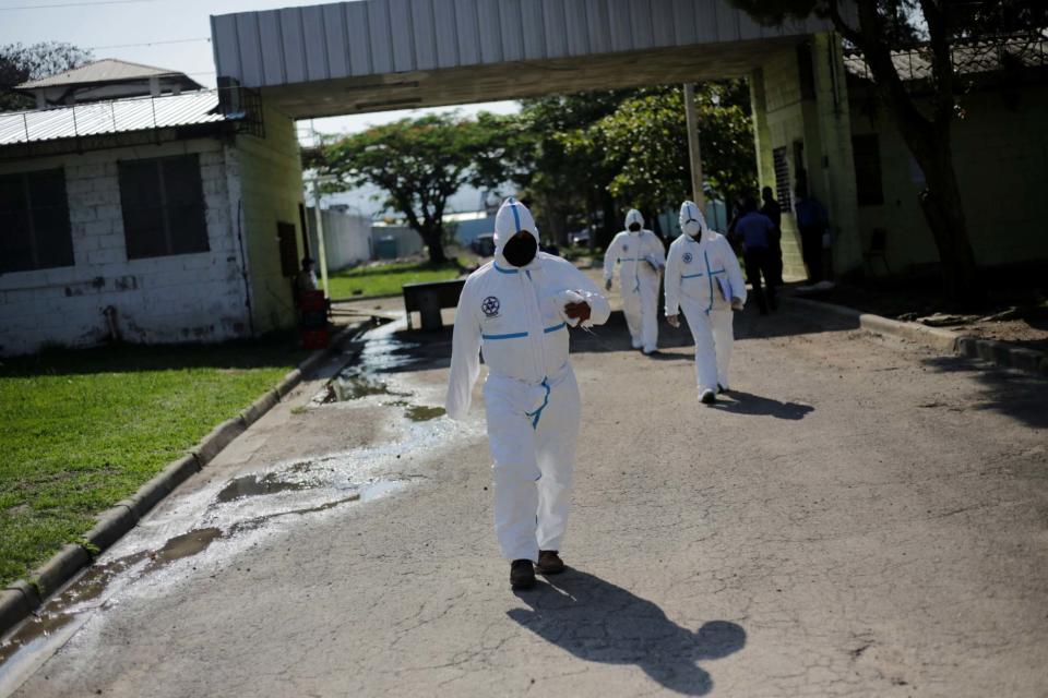 Forensics pictured outside the prison on Sunday (REUTERS)