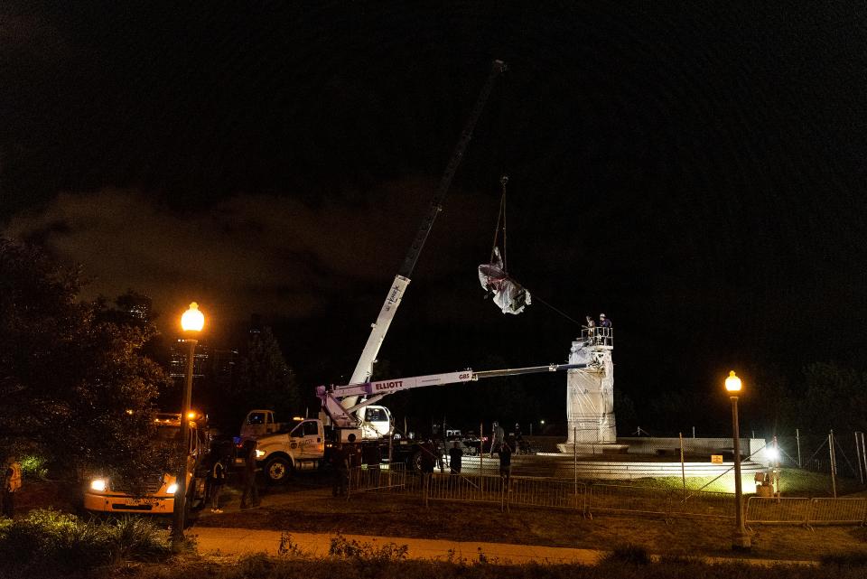 A crane removes the Christopher Columbus statue in Grant Park from its plinth, Friday, July 24, 2020, in Chicago.