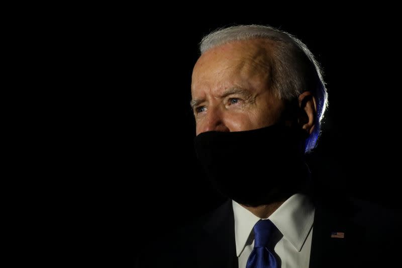 FILE PHOTO: U.S. Democratic presidential candidate Joe Biden looks on as he talks to reporters while leaving, following the final 2020 U.S. presidential campaign debate, at Nashville International Airport in Nashville