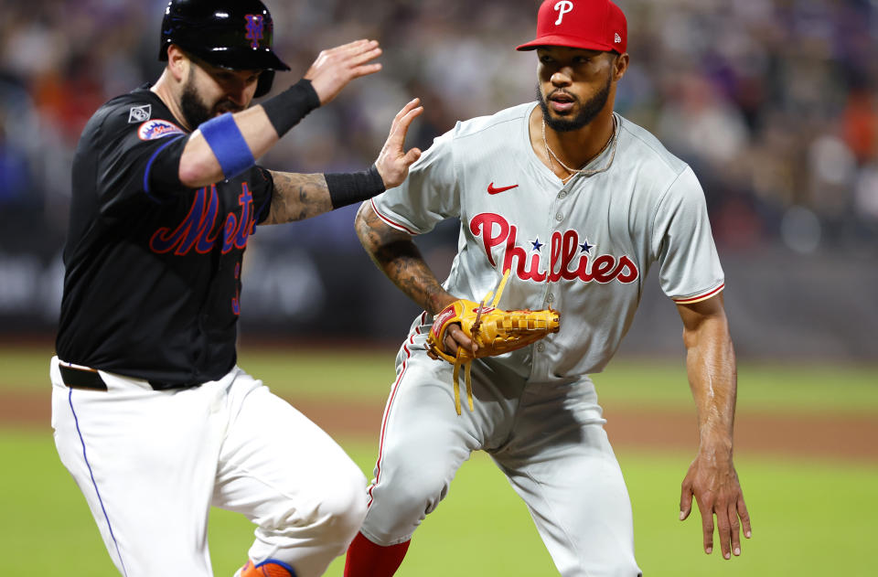 New York Mets' Tomás Nido, left, is safe at first base against Philadelphia Phillies pitcher Cristopher Sánchez, right, after a throwing error during the sixth inning of a baseball game, Monday, May 13, 2024, in New York. (AP Photo/Noah K. Murray)