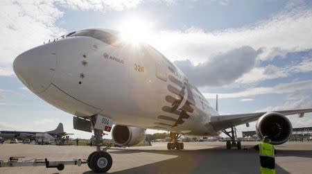 FILE PHOTO - A landing signal officer guides an Airbus A350-900 to be parked for the ILA Berlin Air Show in Selchow near Schoenefeld south of Berlin May 19, 2014. REUTERS/Tobias Schwarz