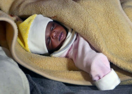 A migrant baby girl is seen sleeping aboard the former fishing trawler Golfo Azzurro, about thirty-two hours after her rescue along other migrants from their drifting plastic rafts by Spanish NGO Proactiva Open Arms, in the Mediterranean Sea, off the Libyan coast April 2, 2017. REUTERS/Yannis Behrakis