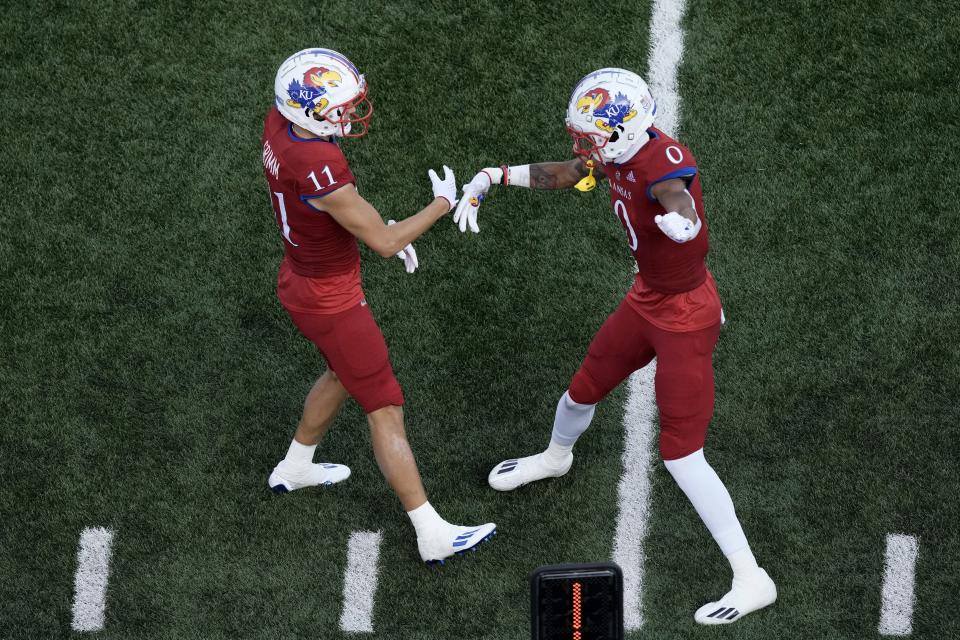 Kansas wide receivers Luke Grimm (11) and Quentin Skinner (0) celebrate after Grimm scored a touchdown during the second half of an NCAA college football game against BYU Saturday, Sept. 23, 2023, in Lawrence, Kan. Kansas won 38-27. | Charlie Riedel, Associated Press
