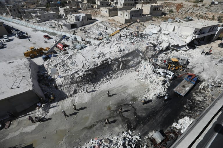 Destroyed buildings are seen on August 12, 2018 following an explosion that reportedly killed 12 people at an arms depot in a residential area in the Syrian town of Sarmada, Idlib province