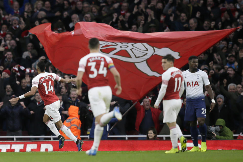 Arsenal's Pierre-Emerick Aubameyang, left, celebrates after scoring his side's second goal during the English Premier League soccer match between Arsenal and Tottenham Hotspur at the Emirates Stadium in London, Sunday Dec. 2, 2018. (AP Photo/Tim Ireland)