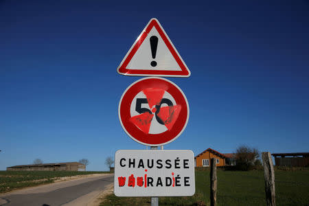 A nuclear warning symbol and the word "irradiated" are painted on road signs in the village of Bure, France, April 6, 2018. REUTERS/Vincent Kessler