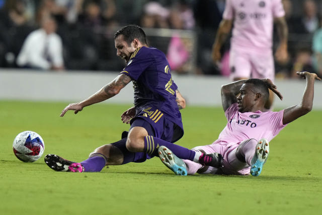 Orlando City defender Kyle Smith, left, and Inter Miami midfielder Dixon Arroyo, right, fall to the pitch during the first half of an MLS soccer match, Saturday, May 20, 2023, in Fort Lauderdale, Fla. (AP Photo/Lynne Sladky)