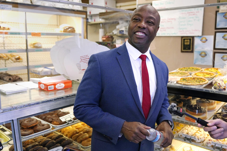 Republican presidential candidate Sen. Tim Scott, R-S.C., smiles while speaking with reporters during a campaign stop at a bakery, Wednesday, Sept. 20, 2023, in Windham, N.H. (AP Photo/Charles Krupa)
