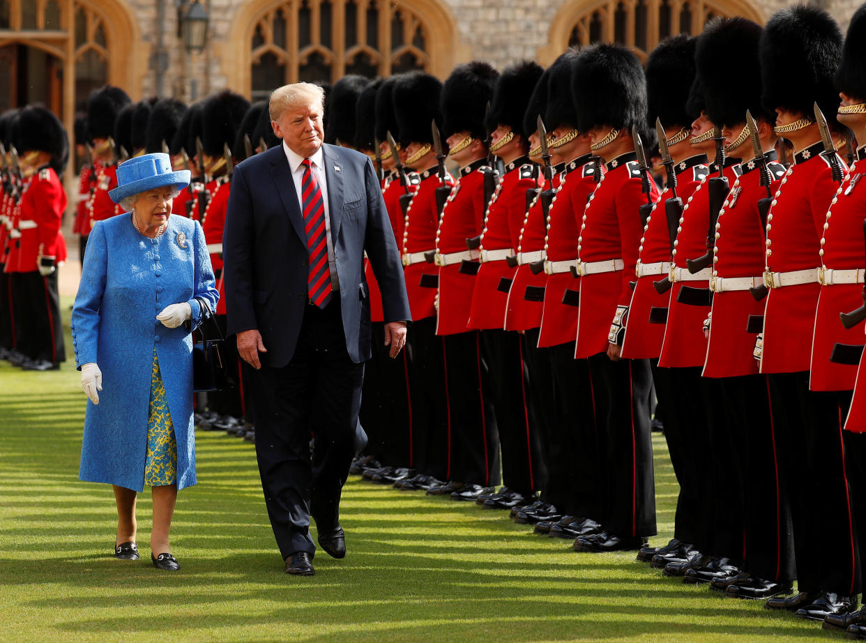 President Donald Trump and Britain's Queen Elizabeth inspect the Coldstream Guards during a visit Friday to Windsor Castle. (Photo: Kevin Lamarque / Reuters)