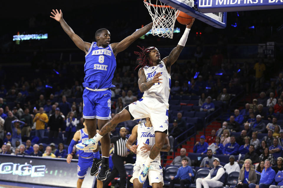 Tulsa guard Cobe Williams (24) shoots a layup past Memphis forward David Jones (8) during the second half of an NCAA college basketball game Thursday, Jan. 4, 2024, in Tulsa, Okla. (AP Photo/Joey Johnson)