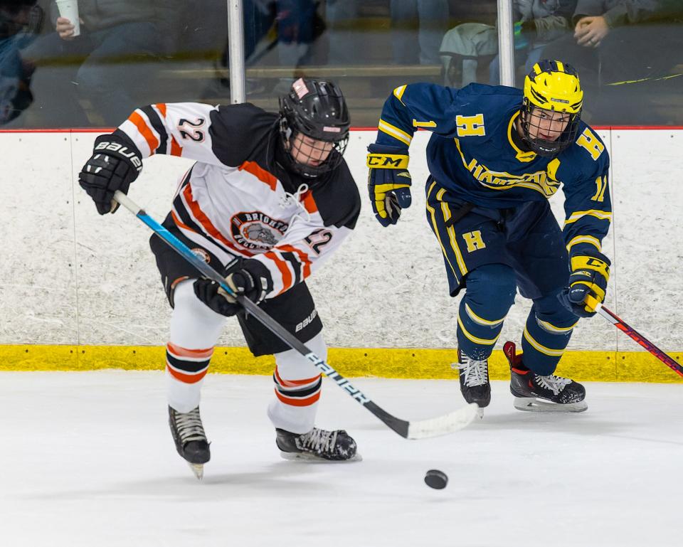 Hartland's Ben Pouliot (11) pursues Brighton's Lane Petit (22) during the Eagles' 2-1 victory on Saturday, Jan. 15, 2022 at Kensington Valley Ice House.