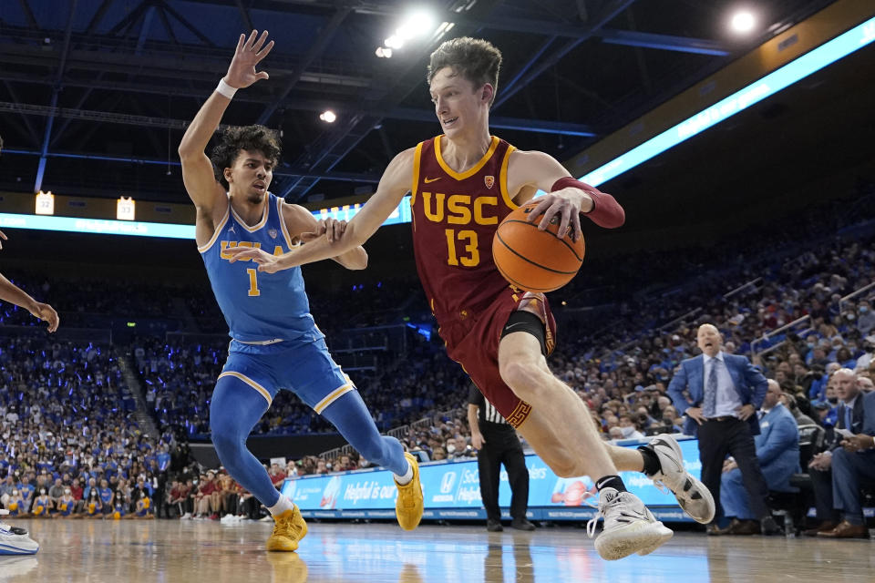 Southern California guard Drew Peterson, right, drives past UCLA guard Jules Bernard during the first half of an NCAA college basketball game Saturday, March 5, 2022, in Los Angeles. (AP Photo/Mark J. Terrill)