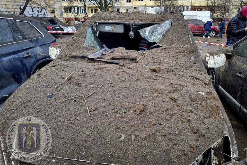 In this photo provided by Serhii Popko, the head of the city's military administration, damaged cars are seen at the site after Russian attacks in Kyiv, Ukraine, Thursday, March 21, 2024. Around 30 cruise and ballistic missiles were shot down over Kyiv on Thursday morning, according Serhii Popko. The missiles were entering Kyiv simultaneously from various directions in a first missile attack on the capital in 44 days. (Serhii Popko, the head of the city's military administration via AP)