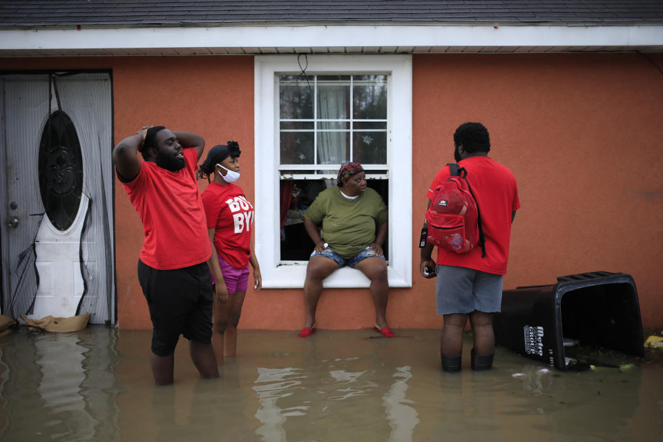 Residents wait to be rescued by first responders from floodwaters in LaPlace, La., on Monday.