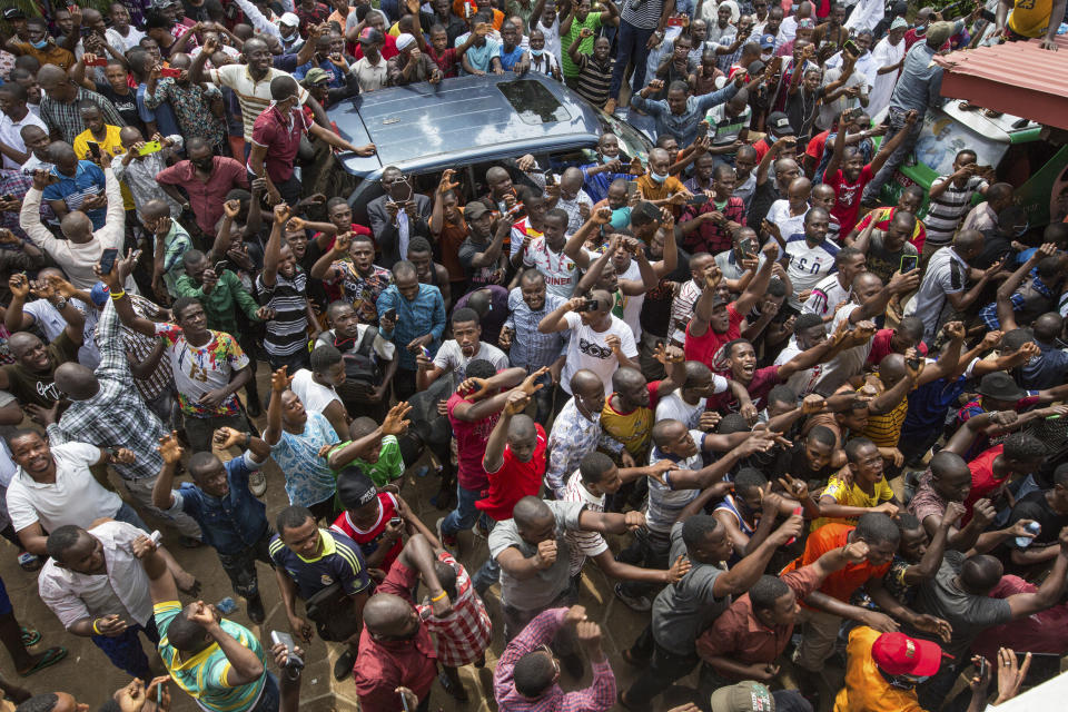 Supporters of Guinean opposition leader Cellou Dalein Diallo cheer at his headquarters in Conakry, Guinea, Monday Oct. 19, 2020. Diallo declared himself the winner after the country held an election on Sunday with Guinean President Alpha Conde seeking to extend his decade in power. (AP Photo/Sadak Souici)