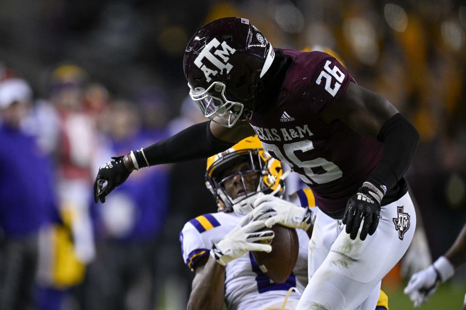 Nov 26, 2022; College Station, Texas; Texas A&M Aggies defensive back Demani Richardson (26) hits LSU Tigers wide receiver Malik Nabers (8) after he makes the catch during the second half at Kyle Field. Jerome Miron-USA TODAY Sports