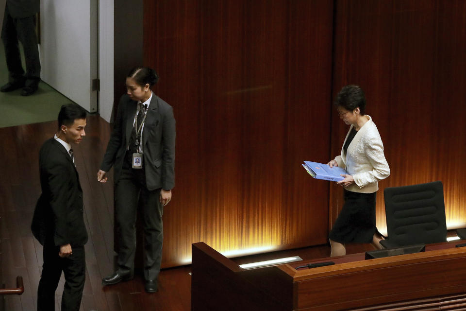 Hong Kong Chief Executive Carrie Lam, right, leaves after attending a question and answer session with lawmakers at the chamber of the Legislative Council in Hong Kong, Thursday, Oct. 17, 2019. (AP Photo/Mark Schiefelbein)