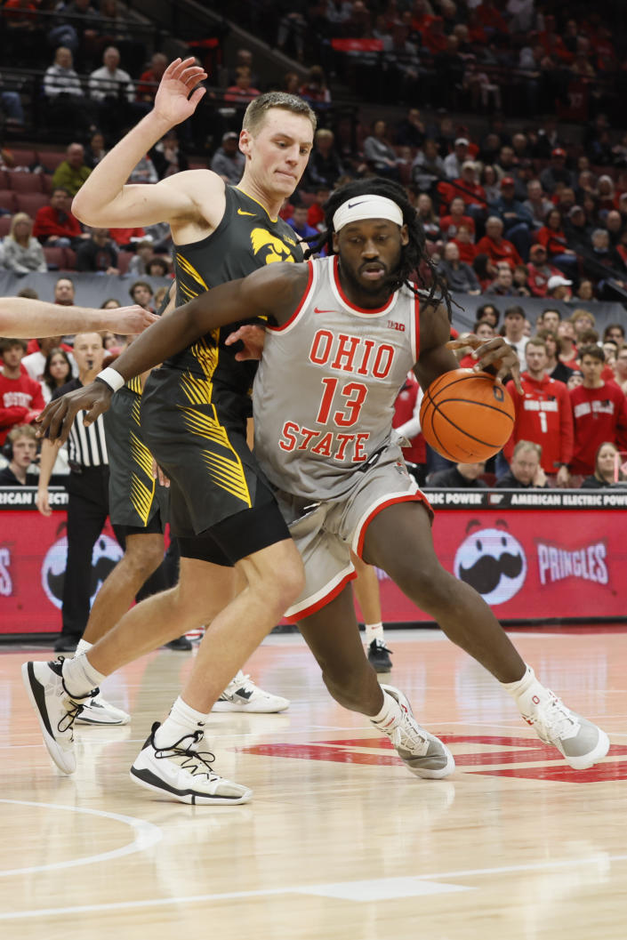 Ohio State's Isaac Likekele, right, drives to the basket against Iowa's Payton Sandfort during the second half of an NCAA college basketball game on Saturday, Jan. 21, 2023, in Columbus, Ohio. (AP Photo/Jay LaPrete)