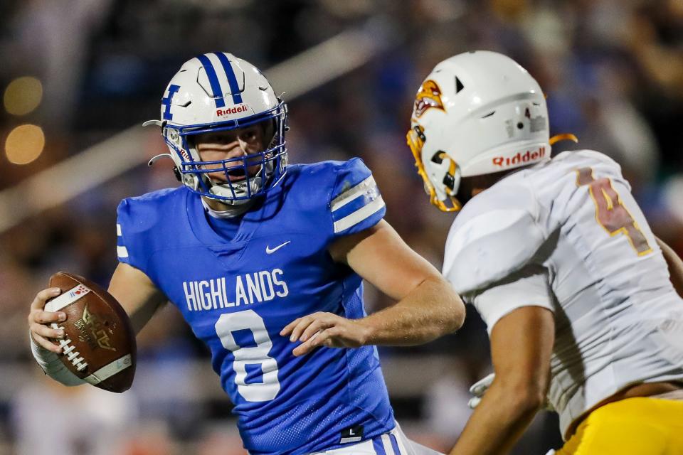 Highlands quarterback Brody Benke (8) runs with the ball during a two-point conversion in the second half against Cooper linebacker Austin Alexander (4) in the second half at Highlands High School Nov. 24, 2023.