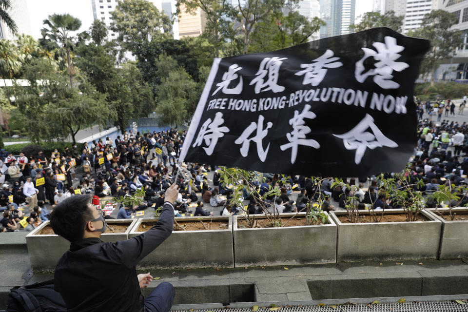 FILE - A pro-democracy supporter waves a flag during a rally in Hong Kong on Dec. 2, 2019. Hong Kong began work on a local National Security Law on Tuesday, Jan. 30, 2024, more than three years after Beijing imposed a similar law that has all but wiped out dissent in the semi-autonomous city. (AP Photo/Vincent Thian, File)