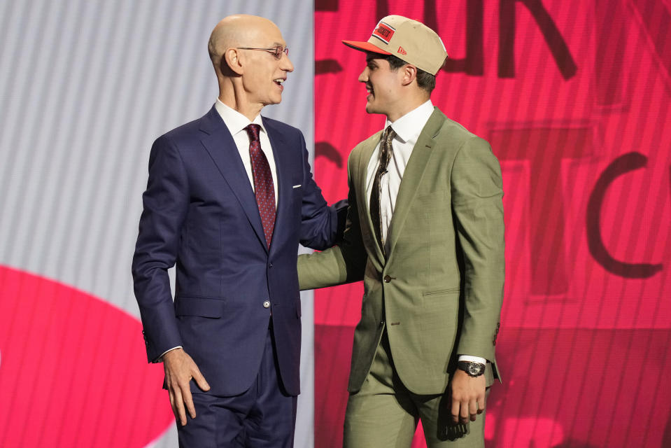 Reed Sheppard, right, greets NBA commissioner Adam Silver after being selected third overall by the Houston Rockets during they first round of the NBA basketball draft, Wednesday, June 26, 2024, in New York. (AP Photo/Julia Nikhinson)