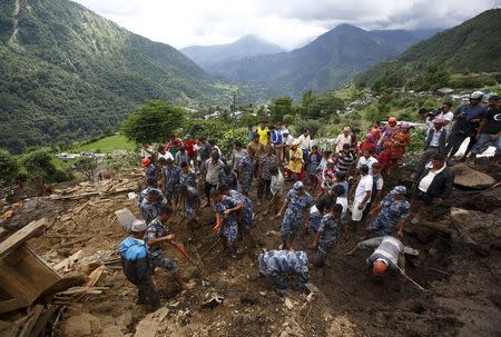 Rescue team members search for landslide victims at Lumle village in Kaski district July 30, 2015. REUTERS/Navesh Chitrakar