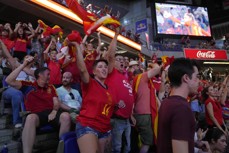 Spanish fans cheer in front of large screens after Spain's Olga Carmona scored the opening goal during the Women's World Cup final soccer match between Spain and England in Madrid, Spain, Sunday, Aug. 20, 2023. (AP Photo/Paul White)