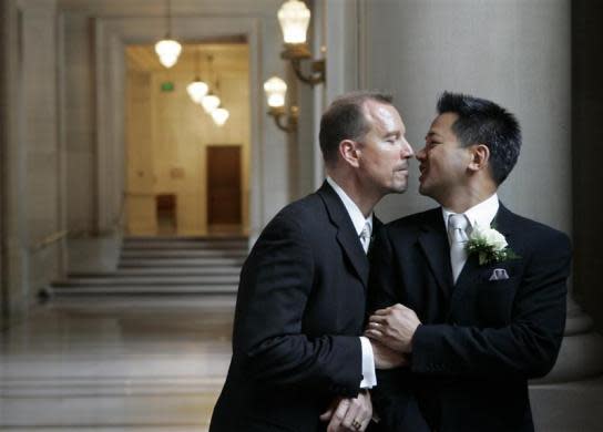 Same-sex couple Stuart Hata (R) and Mark Cadena share a private moment in City Hall after their wedding ceremony in San Francisco, California November 3, 2008.