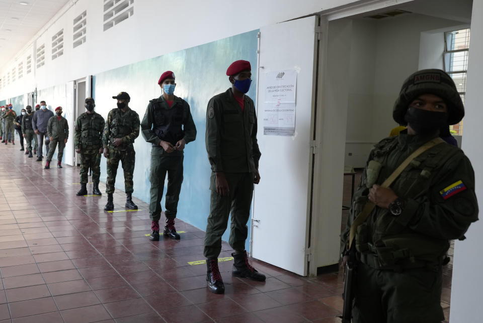Soldiers line up to vote during regional elections, at a polling station in Caracas, Venezuela, Sunday, Nov. 21, 2021. Venezuelans go to the polls to elect state governors and other local officials. (AP Photo/Ariana Cubillos)