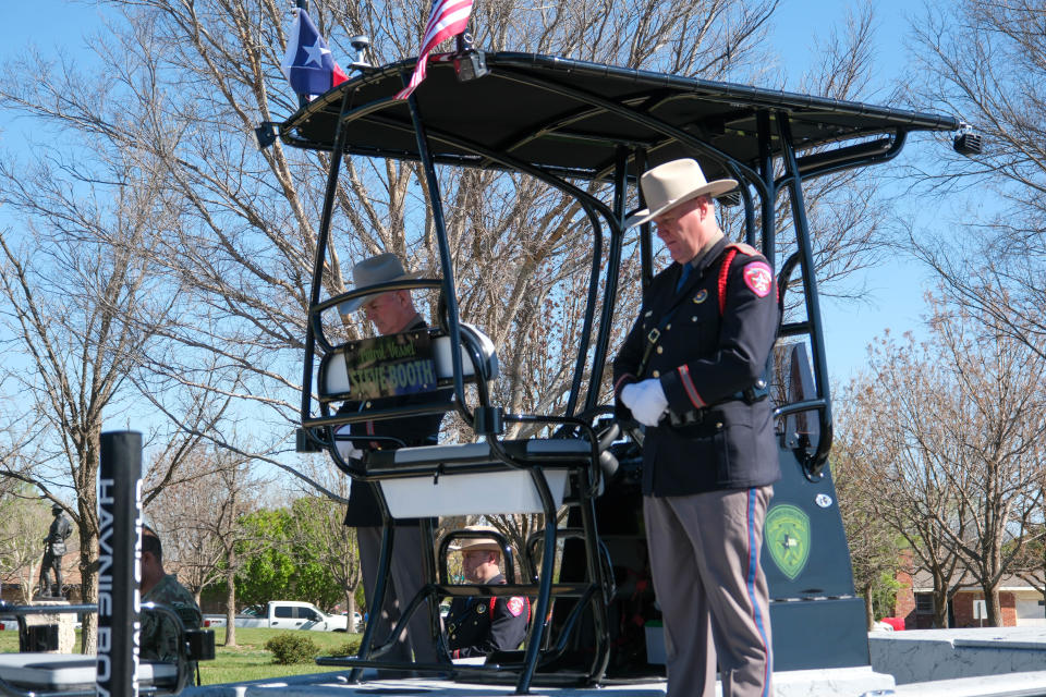 Troopers stand on a boat dedicated to State Trooper Steve Booth on Thursday at the Texas Panhandle War Memorial Center in Amarillo. Booth died in the line of duty on June 16, 1993.