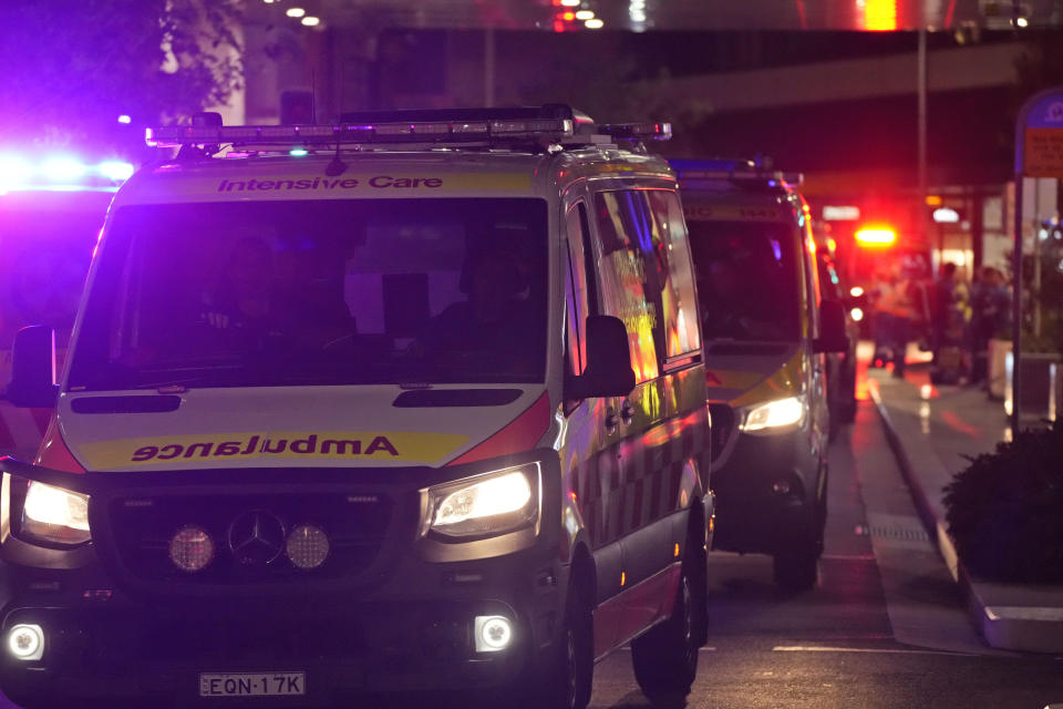 Ambulances leave Westfield Shopping Centre, where multiple people were stabbed in Sydney, Saturday, April 13, 2024. Five people and a suspect were killed in a Sydney shopping center stabbing attack on Saturday that left multiple people, including a small child, injured, police said. (AP Photo/Rick Rycroft)