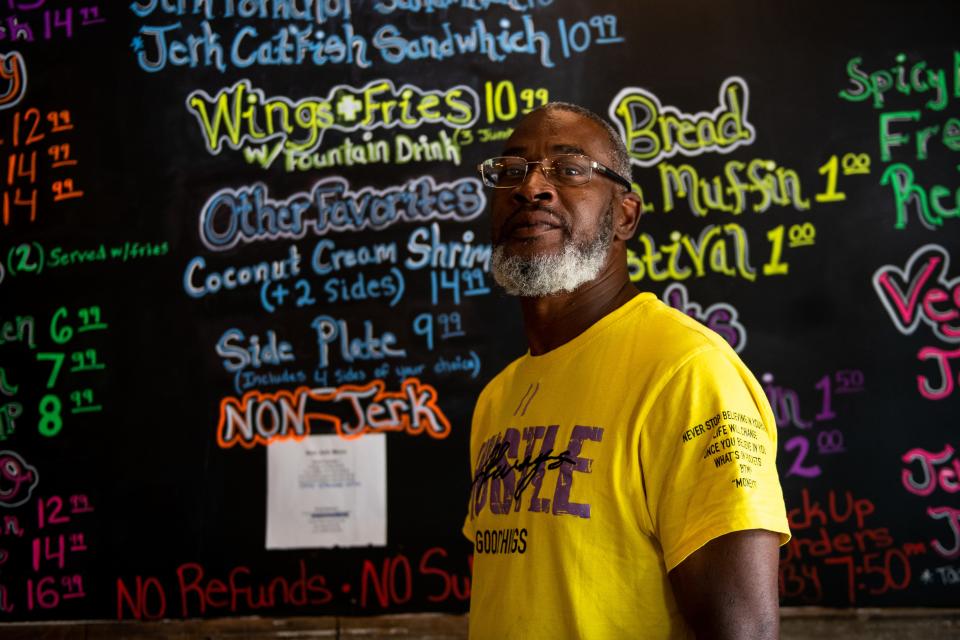 John Sims, the owner and founder of Jerk Hut, poses for a portrait in his restaurant on Tuesday, July 20, 2021. Sims says his experience running previous businesses helped him get the restaurant through the pandemic.