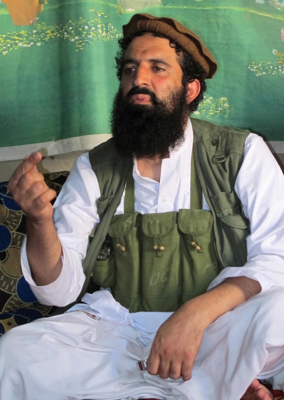 FILE - In this Saturday, Oct. 5, 2013 file photo, Pakistani Taliban spokesman Shahidullah talks to reporters at an undisclosed location in Pakistani tribal area of Waziristan along Afghanistan border. The Pakistani Taliban announced Saturday that the group will observe a one-month cease-fire as part of efforts to negotiate a peace deal with the government, throwing new life into a foundering peace process. Spokesman Shahidullah Shahid said in a statement emailed to reporters that the top leadership of the militant group has instructed all of its units to comply with the cease-fire. (AP Photo/Ishtiaq Mahsud, File)