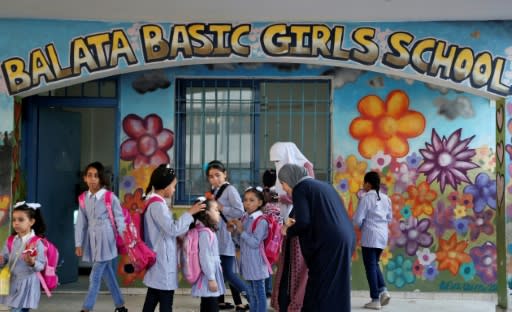 Pupils and teachers gather in front of a school run by UNRWA in Balata refugee camp, east of Nablus in the occupied West Bank on August 29, 2018