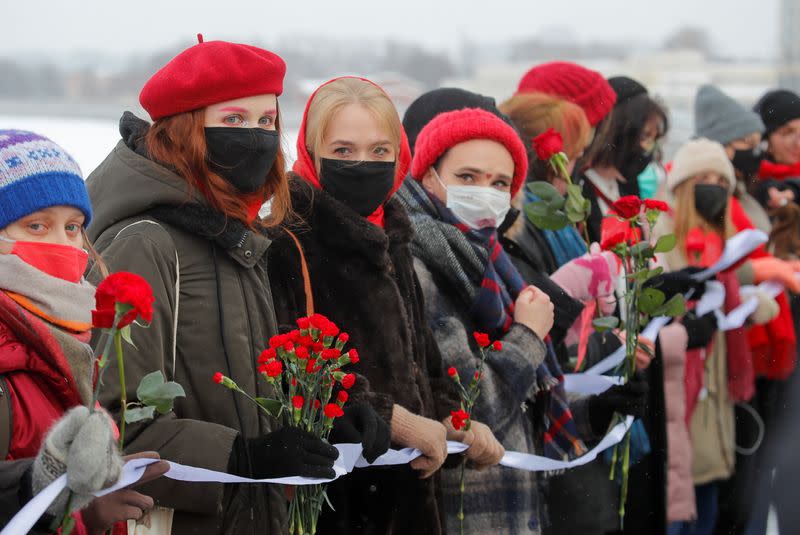 Participants form a human chain during a demonstration to support female political prisoners and to protest against police violence in Saint Petersburg