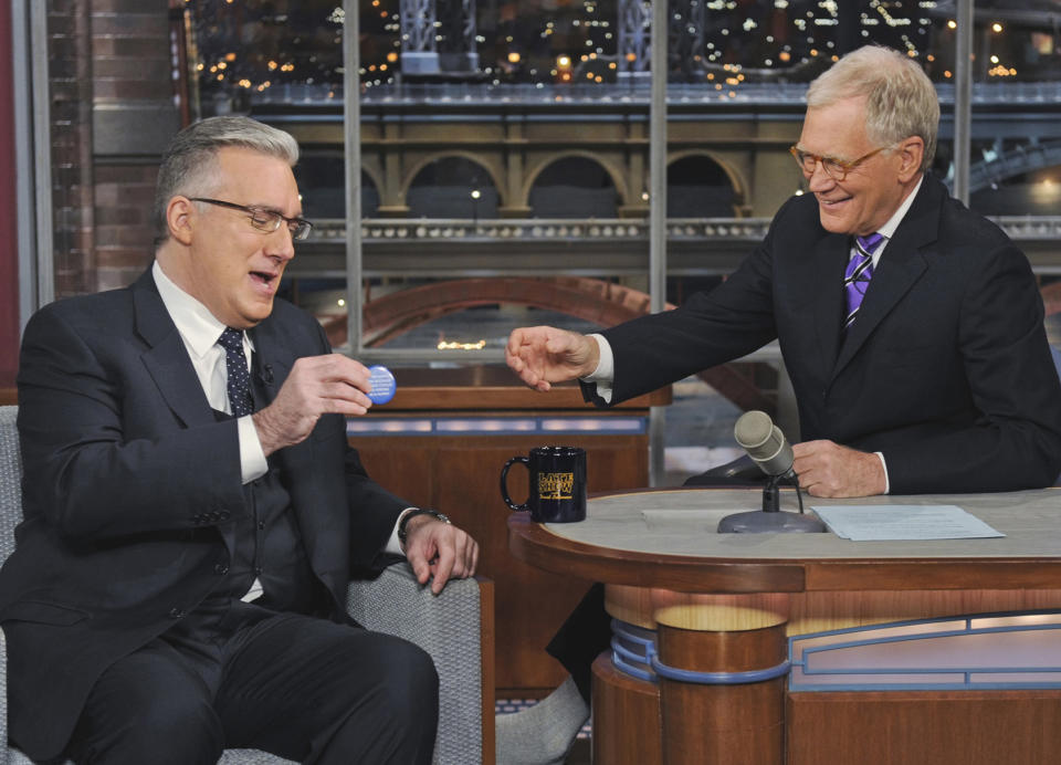 In this photo provided by CBS, talk show host Keith Olbermann, left, chats with host David Letterman on the set of the “Late Show with David Letterman,” Tuesday April 3, 2012 in New York. (AP Photo/CBS, Jeffrey R. Staab) MANDATORY CREDIT; NO ARCHIVE; NO SALES; FOR NORTH AMERICAN USE ONLY