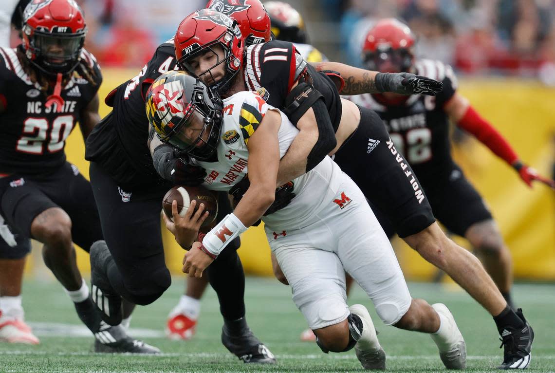 N.C. State linebacker Payton Wilson (11) sacks Maryland quarterback Taulia Tagovailoa (3) during the second half of Maryland’s 16-12 victory over N.C. State in the Duke’s Mayo Bowl at Bank of America Stadium in Charlotte, N.C., Friday, Dec. 30, 2022.