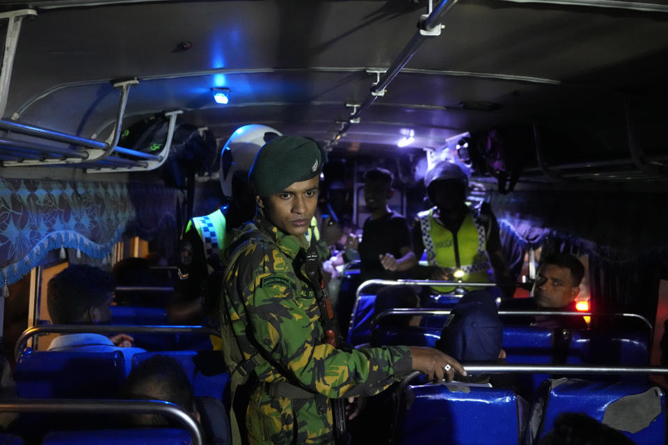 Sri Lankan police officers search a passenger bus during a search operation against narcotics in Colombo, Sri Lanka, Thursday, Jan. 18, 2024. (AP Photo/Eranga Jayawardena)