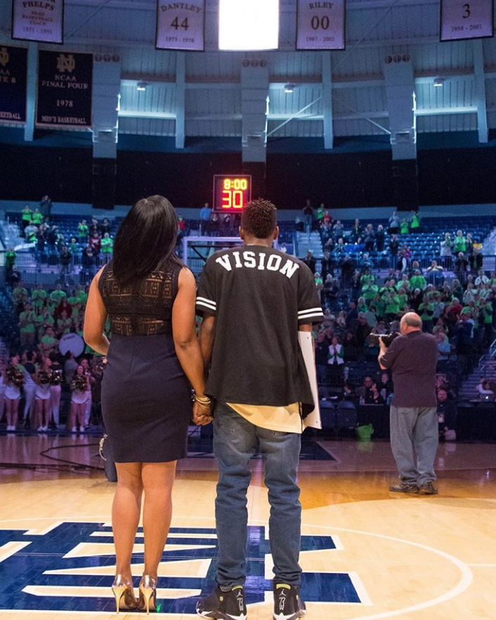 Jaden Ivey holds his mom, Niele Ivey's, hand before a Notre Dame women's basketball game.